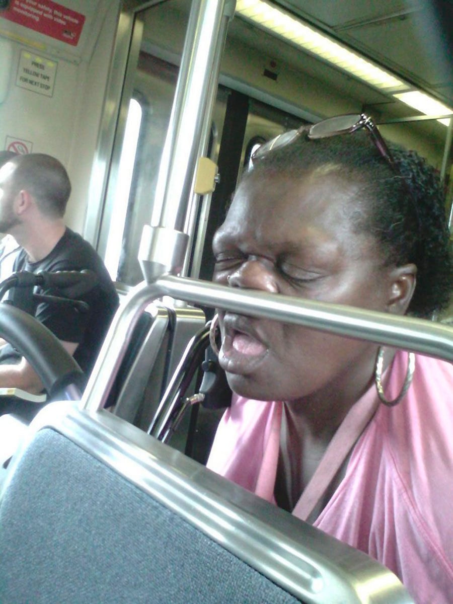 Woman Sleeps Soundly Against Bus Rail