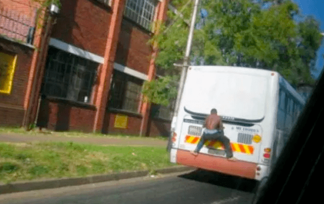 Man Hangs Onto The Outside Of The Bus Jpg