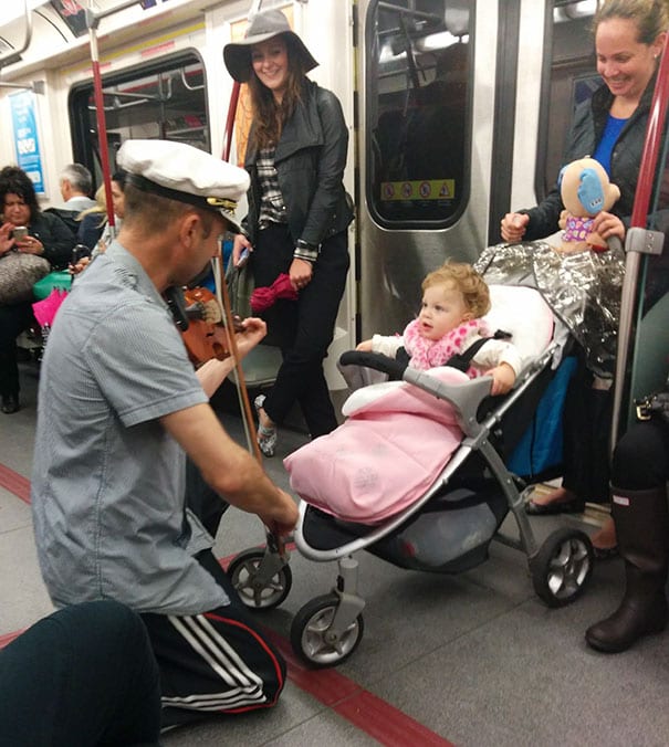 Adorable Moment As Fiddler Calms Baby On The Subway