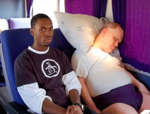 Man Stuck Next To Unfortunate Neighbor On The Train Jpg