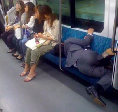 Man Stretches Out On The Subway Seats